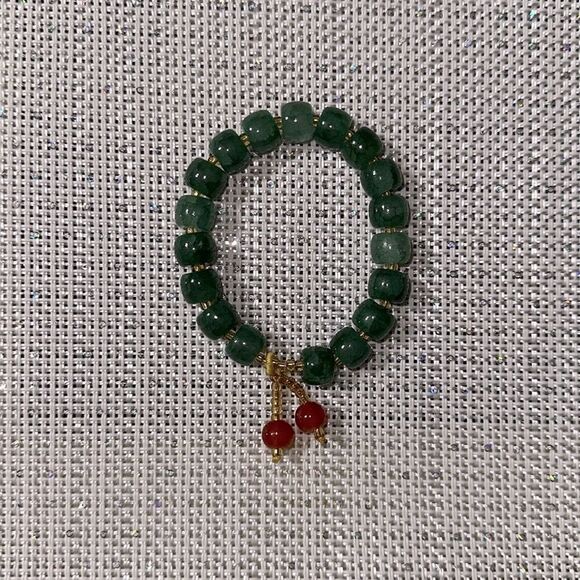 Handmade Green Jade Stretch Bracelet with Small Rust Tasseled Design - Picture 2 of 4